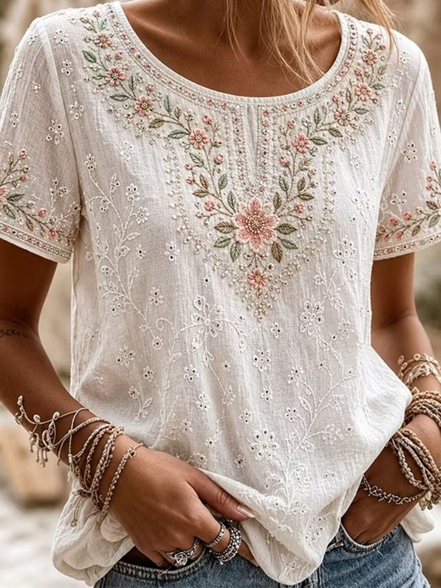 Blusa de flores con cuello redondo, manga corta, pedrería y ojales