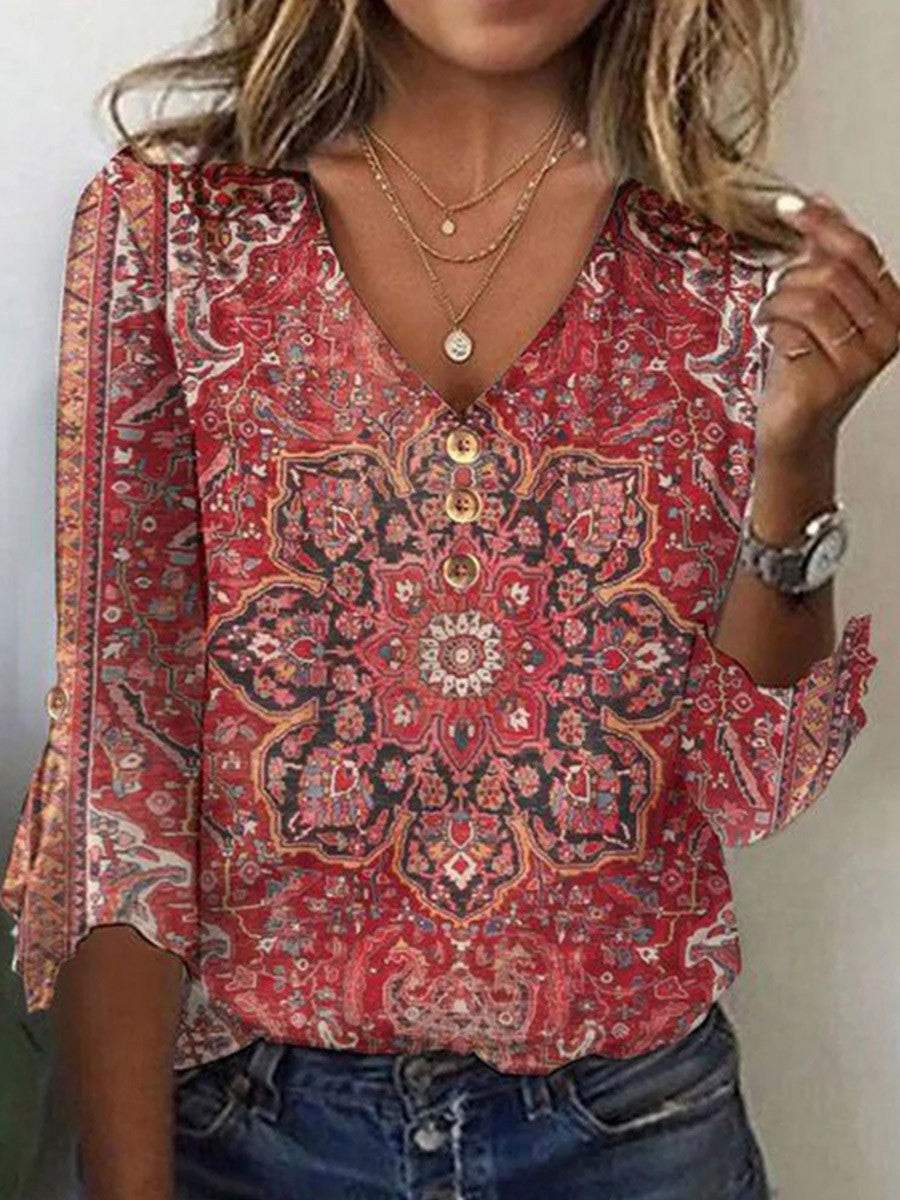 Blusa de flores con escote en pico y manga tres cuartos