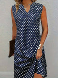 Vestido vintage de lunares azul marino con escote en pico, sin mangas
