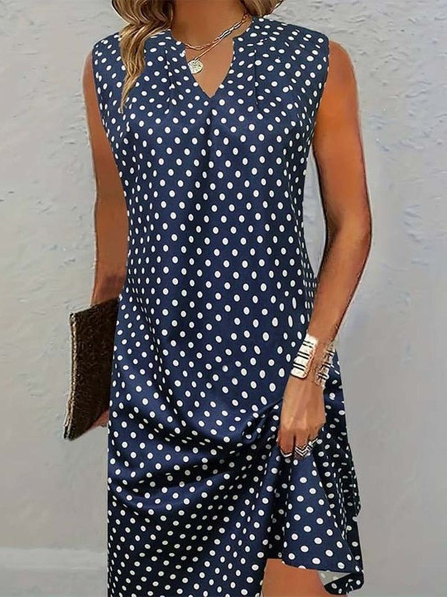Vestido vintage de lunares azul marino con escote en pico, sin mangas