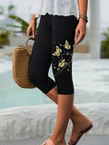 Shorts a media pierna de mariposas negros
