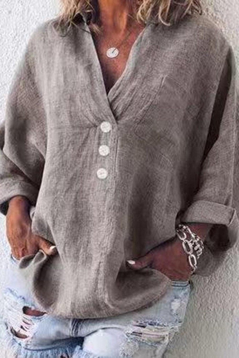 Blusa holgada lisa con escote en pico, manga larga y botones