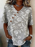 Top de flores gris con escote en pico y manga corta