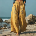 Pantalón ancho bordado de flores con cordón y bolsillos